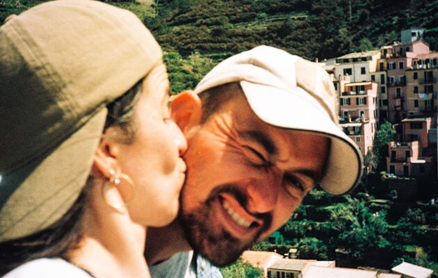 Two people taking selfie while kissing